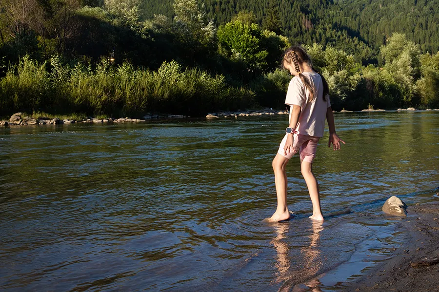 Young girl wading through a swamp - symbolic of moving forward through overwhelm and uncertainty - Houston Therapy for Girls